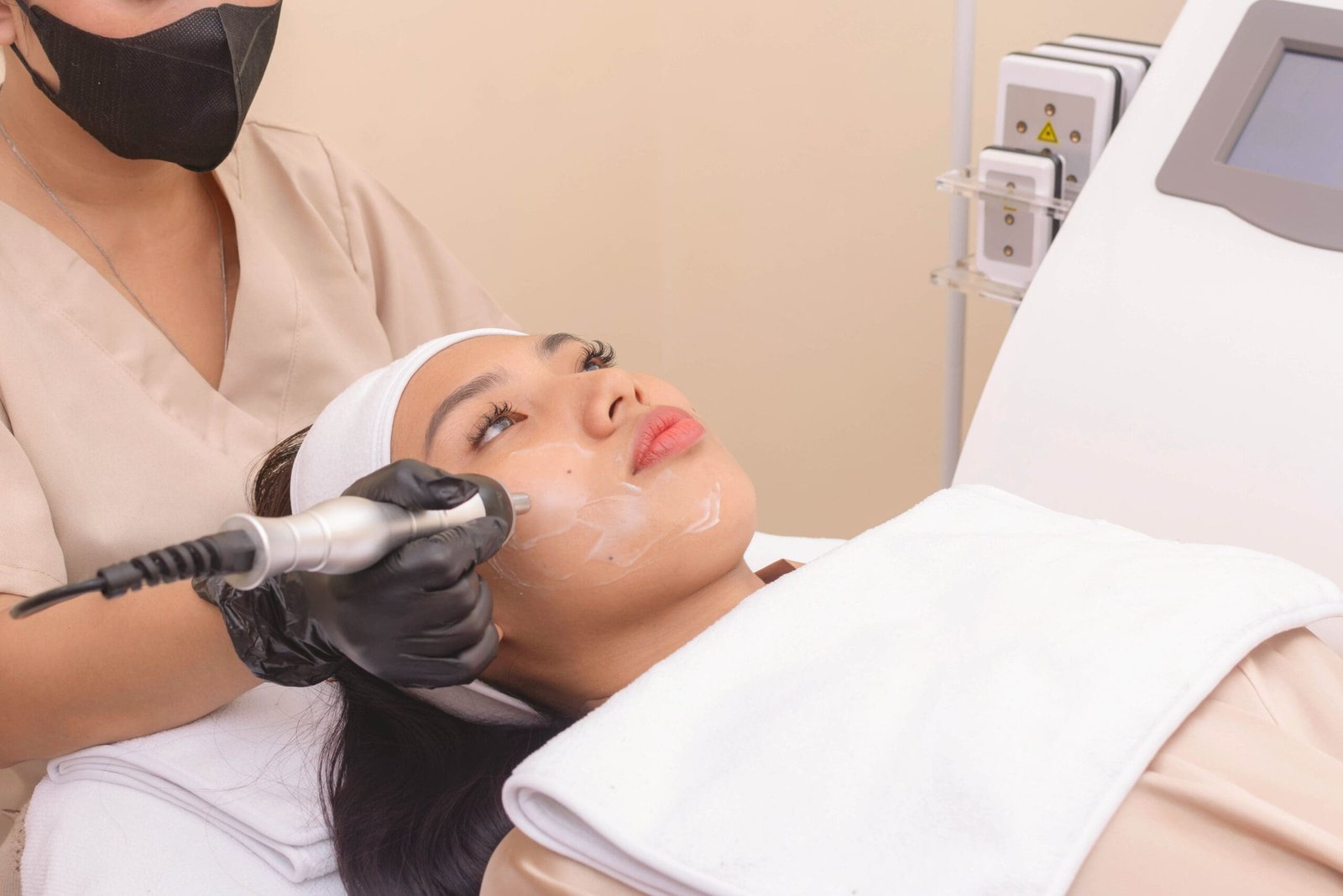 Using an RF electromagnetic device for radiofrequency skin tightening or contouring treatment. At a facial care, dermatologist or aesthetic clinic.; Shutterstock ID 2364561637; downloader_name: -; program_name: -; gateway_project_manager: -; billing_isbn: -